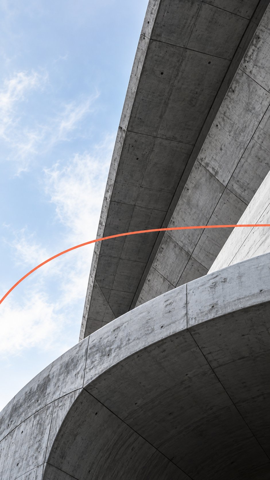 Curved concrete structure against a blue sky, crossed by a thin coral line